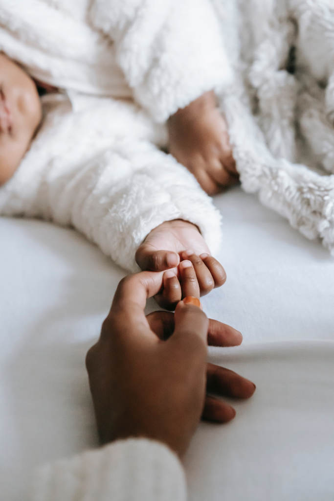 Holding hands with newborn